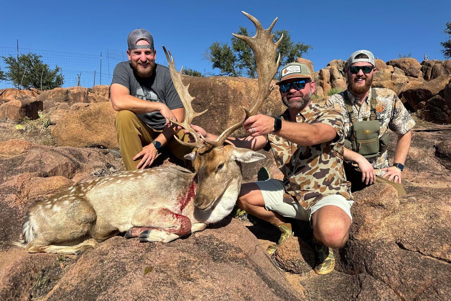 Hunters with a trophy fallow buck at Hollow Point Outfitters