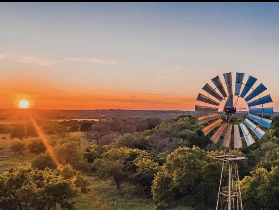 Sunrise over a windmill on the Hill Country ranch
