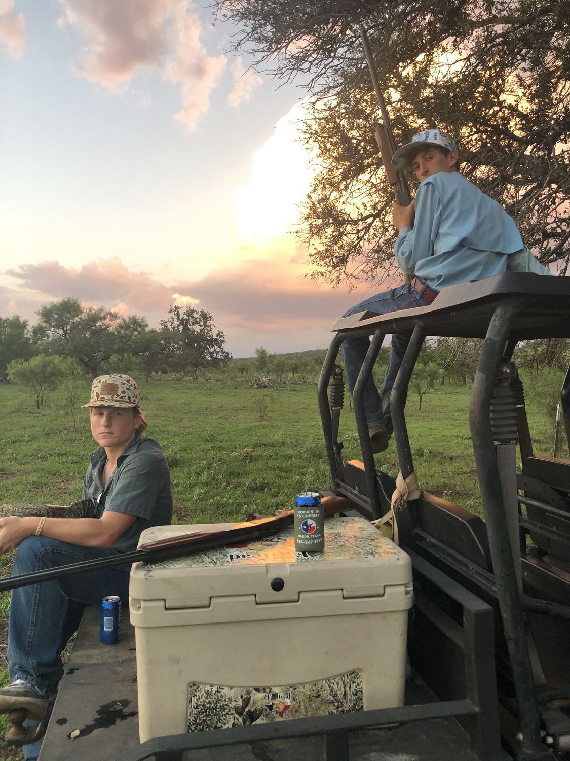 The crew on a UTV at sunset