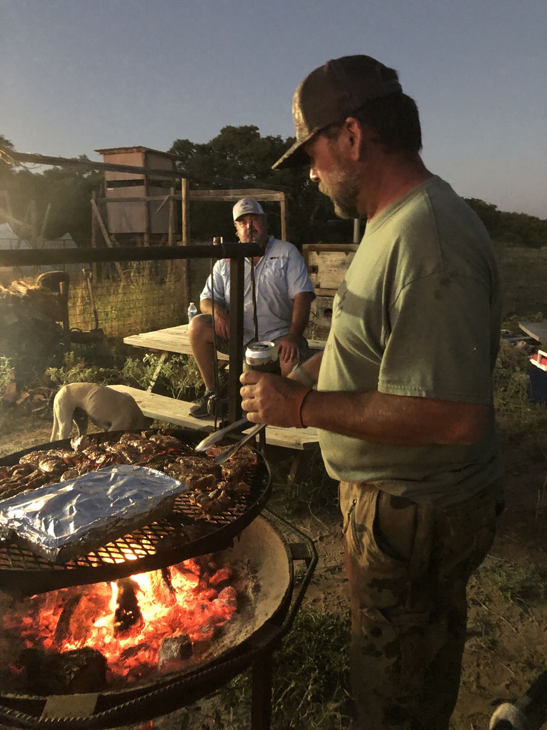 Grilling over an open fire at camp