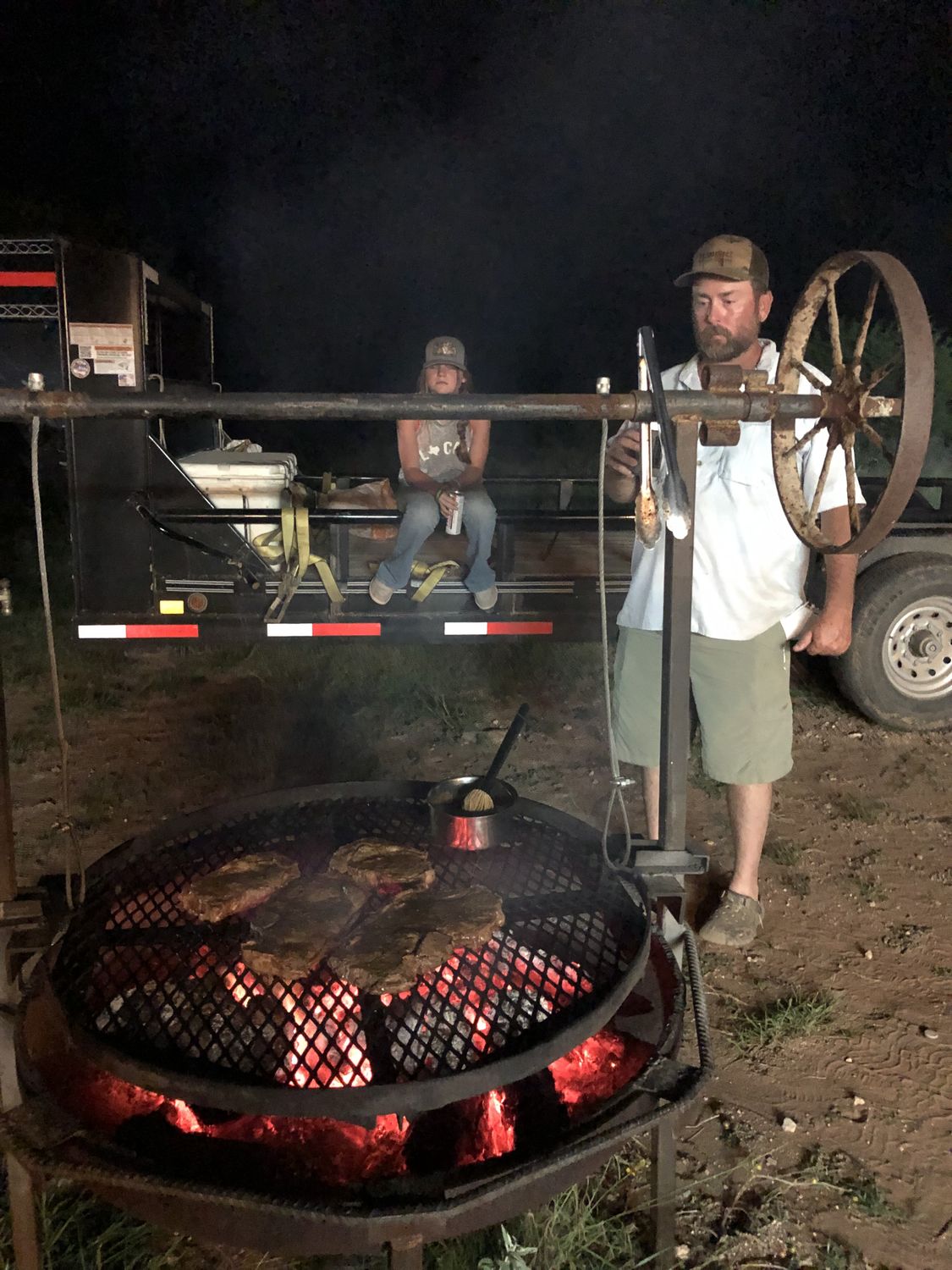 The camp grill loaded up over coals