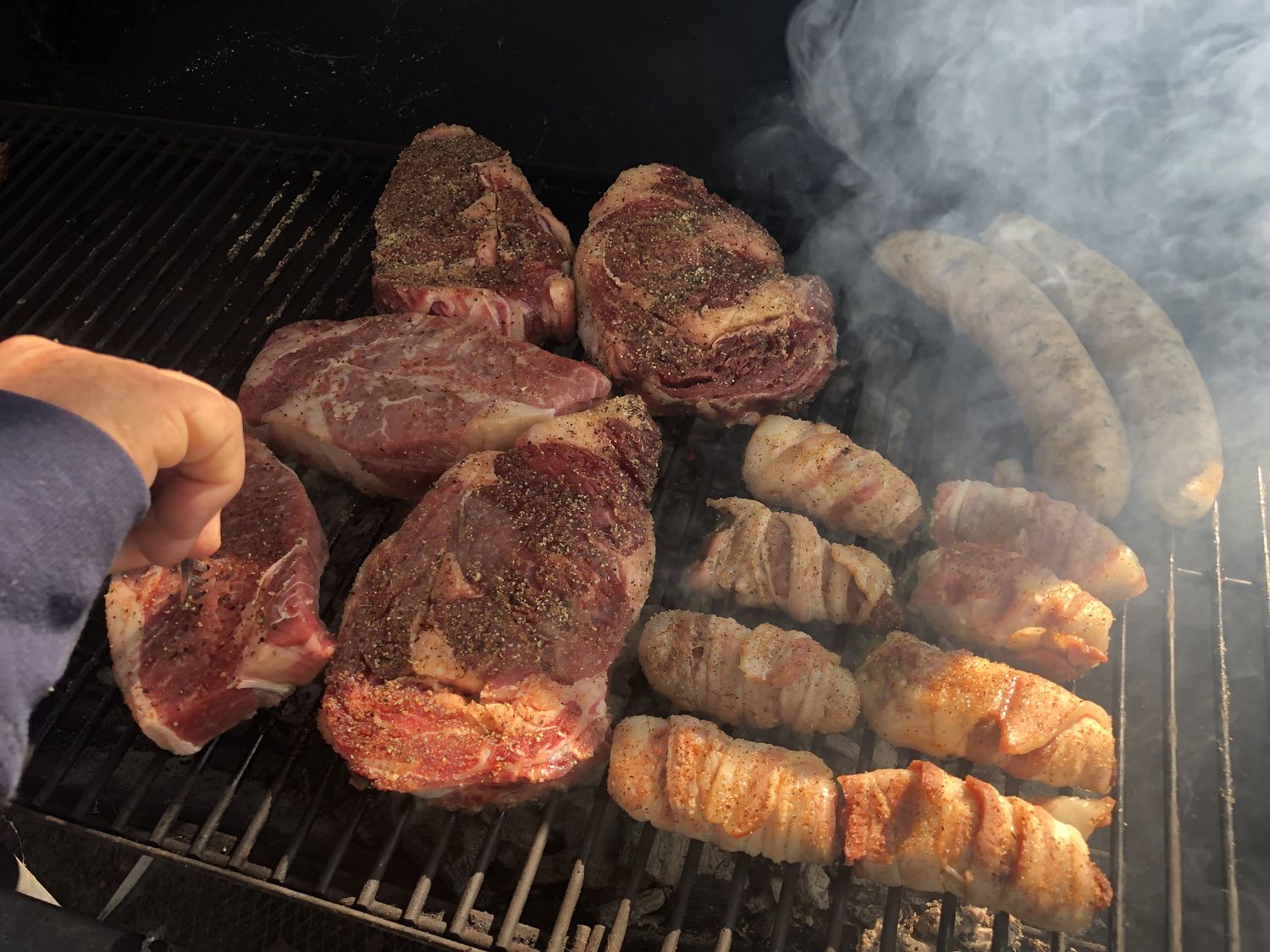 Steaks and bacon-wrapped poppers on the grill