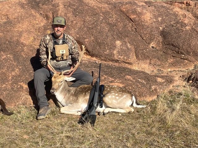 Hunter with a fallow buck