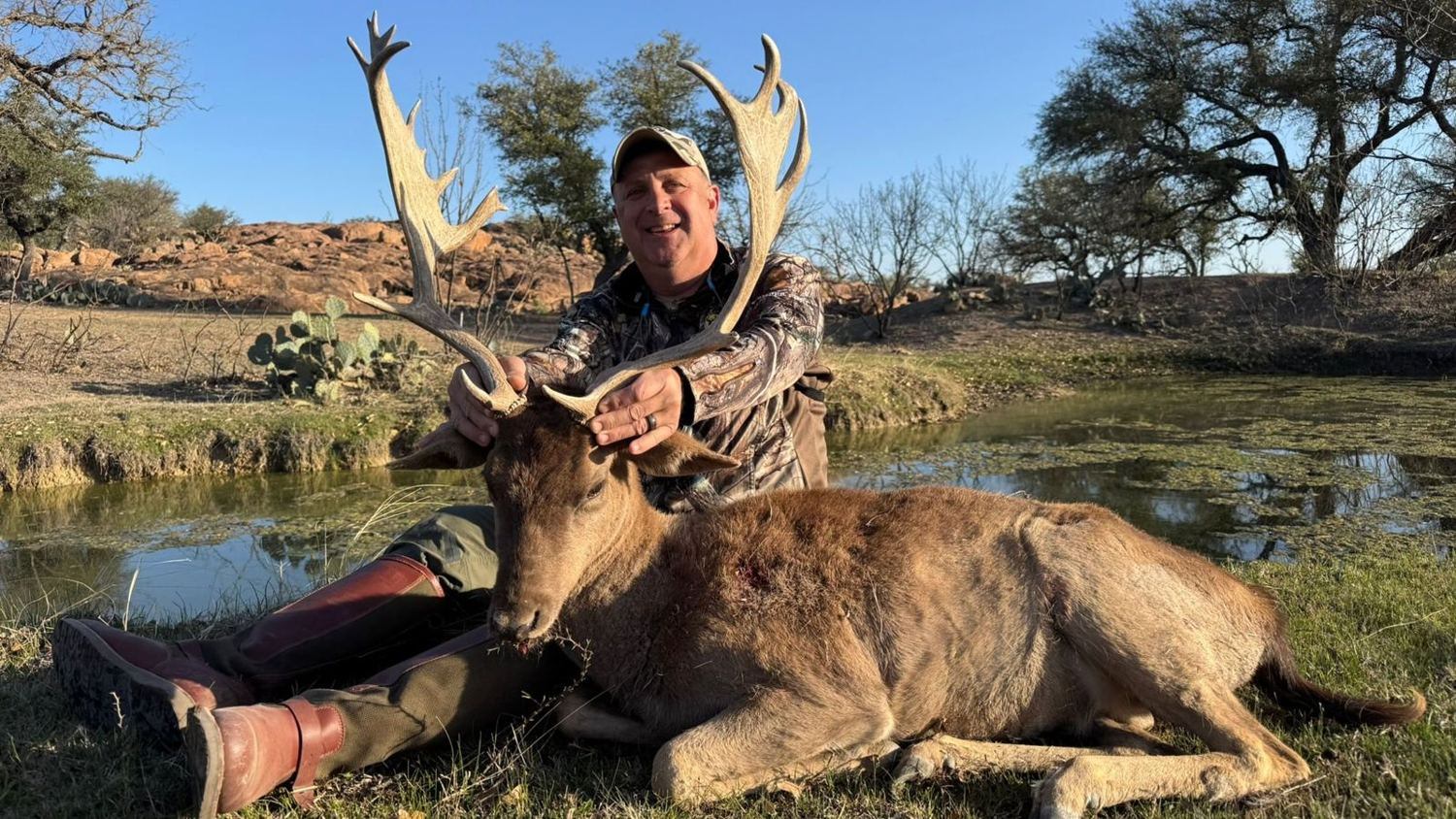 Hunter with a trophy fallow buck by the tank