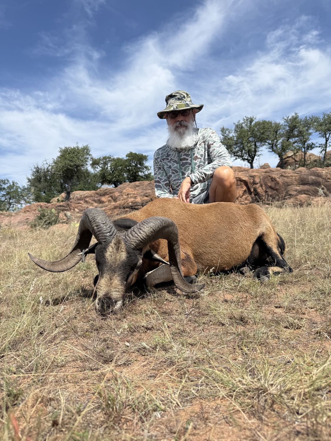 A hunter with a corsican ram taken at Hollow Point Outfitters