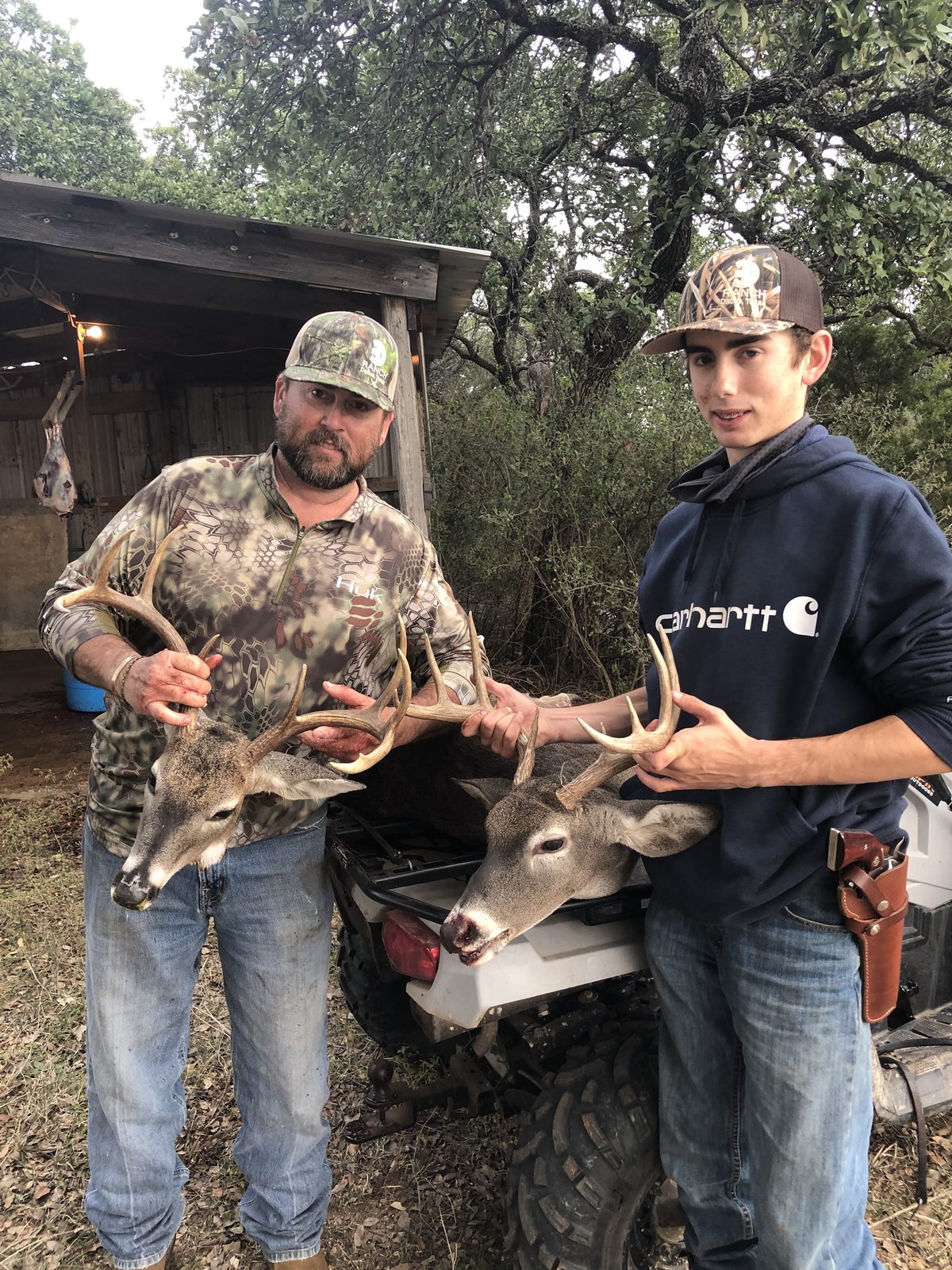 Two hunters with whitetail bucks
